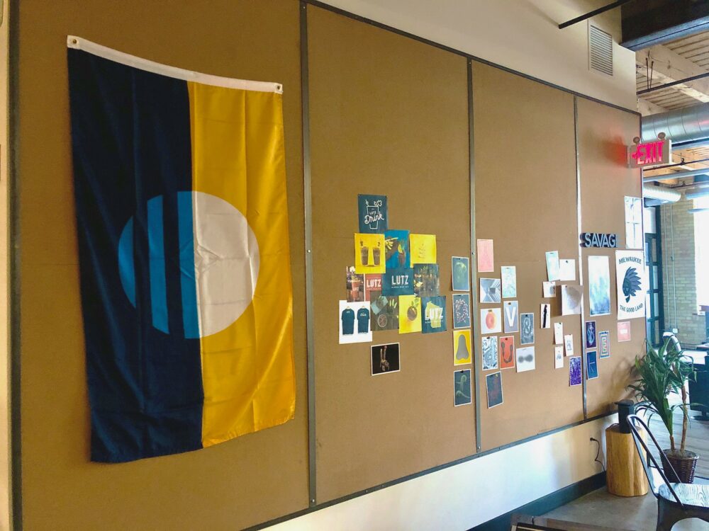 The city of milwaukee flag hanging in the savage office.