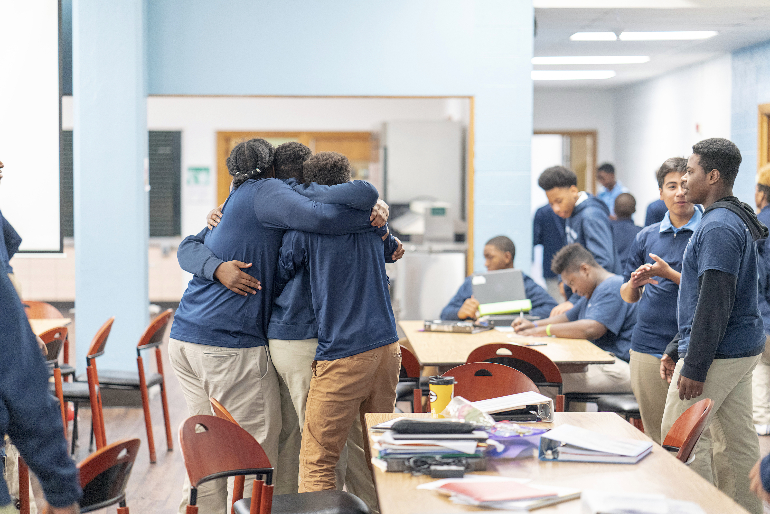 Students at KPLHS huddled together in a classroom.