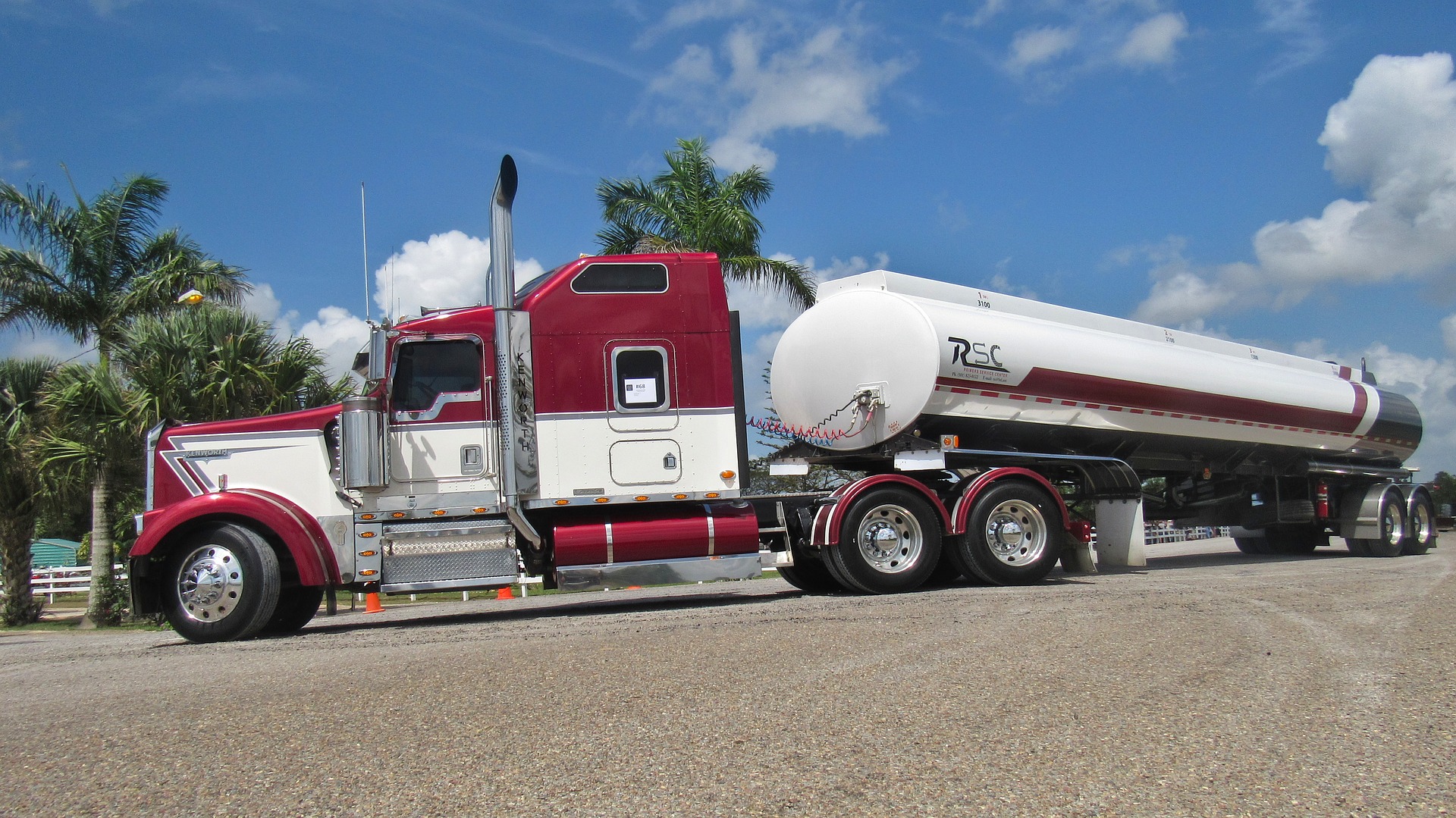 A tank truck driving outside.
